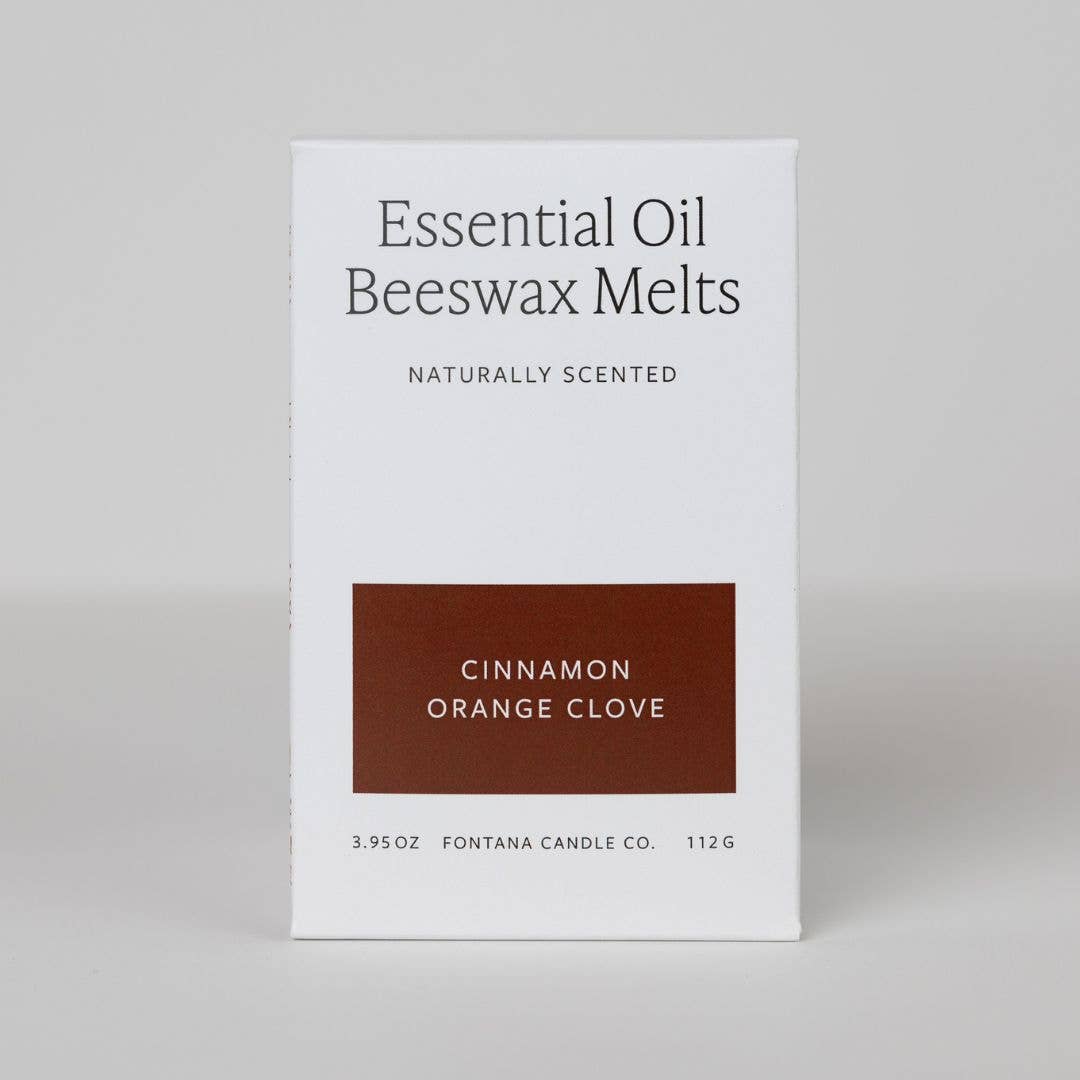 Box of Essential Oil Beeswax Melts with cinnamon, orange, and clove scent on a gray background