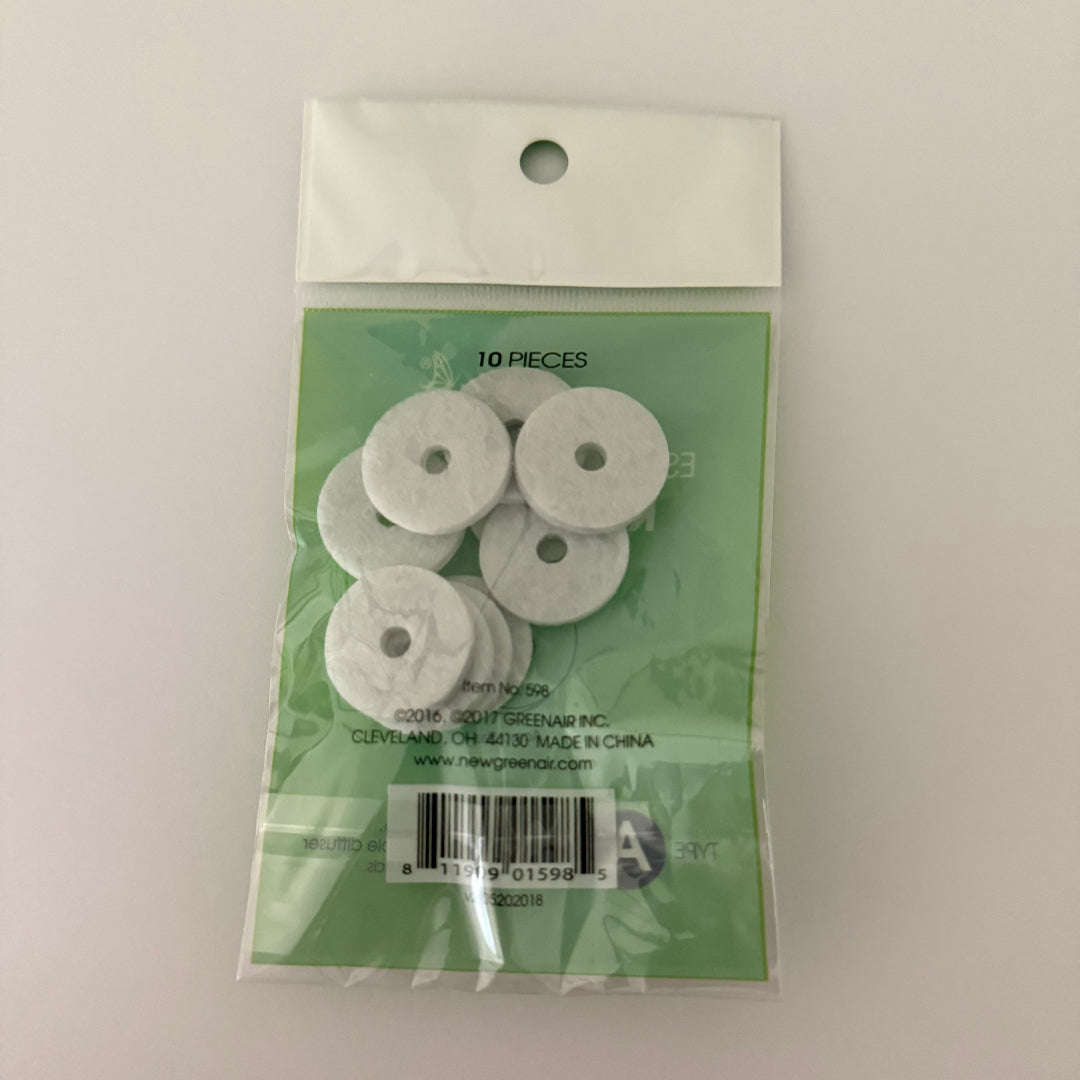 Packaged white circular items with a green label on a light gray background