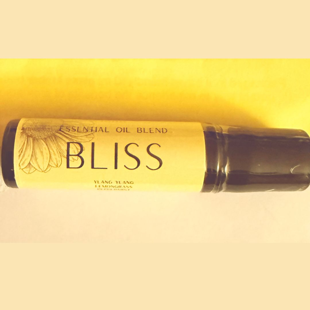 Roll-on bottle of 'Bliss' essential oil blend with a yellow label on a beige background