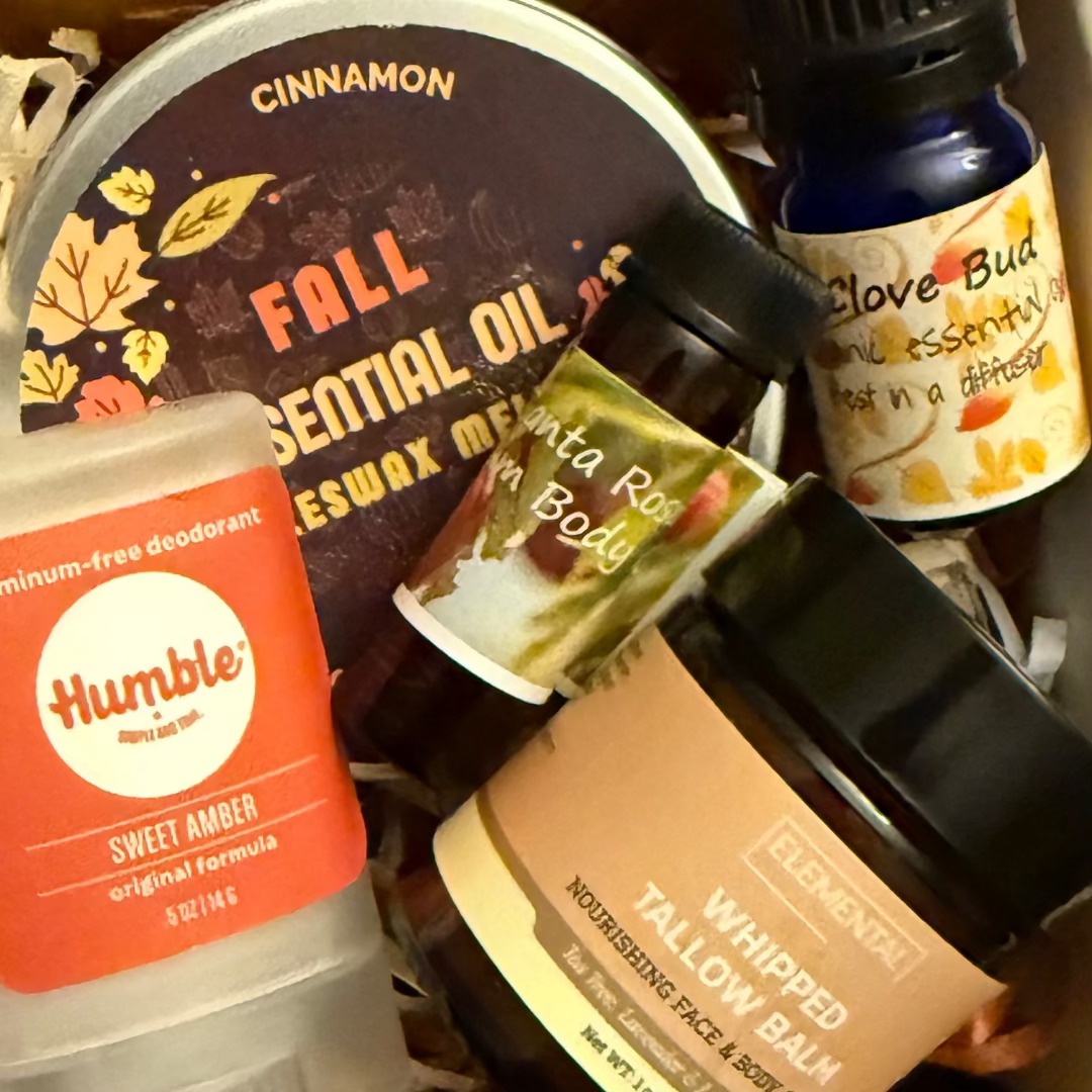 Collection of natural and organic products including a deodorant, essential oils, and balms.